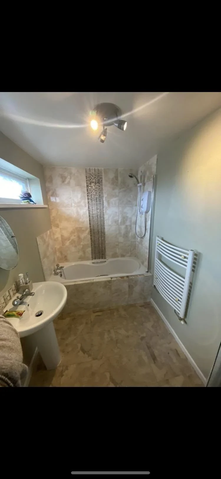 Before renovation: beige bathroom with bath and pedestal basin