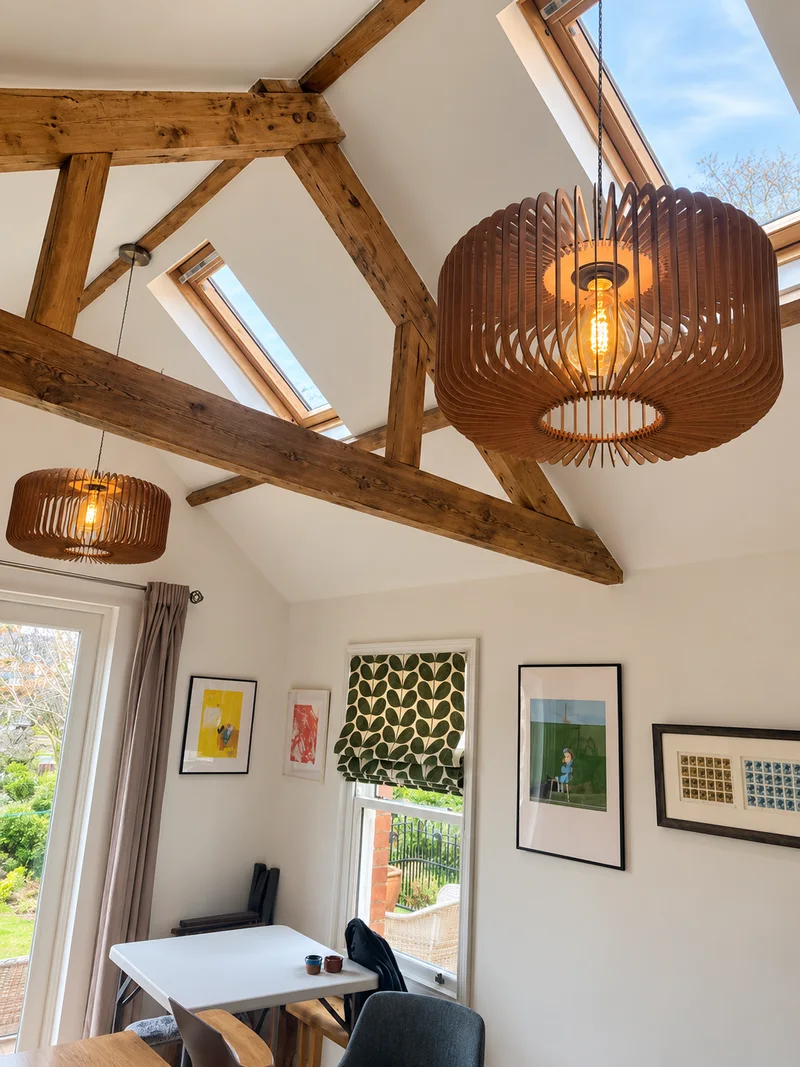 Wooden pendant lights beneath exposed beams; photo enhanced